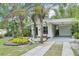 Inviting single-story home with carport, mature landscaping, and a welcoming front entrance at 318 E Jersey St, Orlando, FL 32806