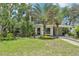 Charming single-story home with lush landscaping, mature trees, and a convenient carport at 318 E Jersey St, Orlando, FL 32806