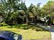 Charming single-story home with mature trees, a lush lawn, and a driveway in a quiet neighborhood at 318 E Jersey St, Orlando, FL 32806