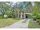 Charming home with lush landscaping, mature trees, and a welcoming front yard, showcasing curb appeal at 318 E Jersey St, Orlando, FL 32806