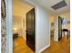 Hallway with hardwood floors leading to bedrooms, featuring neutral walls and modern fixtures at 318 E Jersey St, Orlando, FL 32806