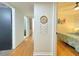Hallway with hardwood floors leading to bedrooms featuring neutral walls and a decorative dream catcher at 318 E Jersey St, Orlando, FL 32806