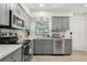 Kitchen featuring updated cabinetry and stainless steel dishwasher at 318 E Jersey St, Orlando, FL 32806