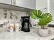 Modern kitchen features a decorative backsplash and stylish decor, complemented by granite countertops at 318 E Jersey St, Orlando, FL 32806