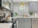 This is a kitchen boasting sleek gray cabinets, modern hardware, and stainless steel appliances at 318 E Jersey St, Orlando, FL 32806