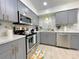 The kitchen features stainless steel appliances, gray cabinets, and granite countertops at 318 E Jersey St, Orlando, FL 32806