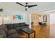 Open-concept living space with hardwood floors, comfortable seating, and a stylish dining area at 318 E Jersey St, Orlando, FL 32806