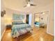 Bright main bedroom with stylish decor, hardwood floors, and ample closet space at 318 E Jersey St, Orlando, FL 32806