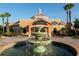 A regal resort-style building with lush landscaping and a beautiful fountain in the front at 3643 Calabria Avenue, Davenport, FL 33897