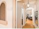 Hallway view leading to the living room showcasing hardwood floors and an arched doorway at 3643 Calabria Avenue, Davenport, FL 33897