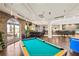This open floorplan has a pool table, bar, and tables for dining and socializing at 3643 Calabria Avenue, Davenport, FL 33897