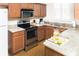 Well-equipped kitchen featuring stainless steel appliances, wood cabinets and granite countertops at 3643 Calabria Avenue, Davenport, FL 33897