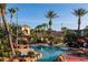 Beautiful free form pool surrounded by lush tropical landscaping, rock features and a small cabana at 3643 Calabria Avenue, Davenport, FL 33897