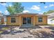 Back exterior view features a covered porch, windows, and access to the home at 3795 Rachel St, Apopka, FL 32703