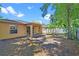 The house's covered porch overlooks the backyard with banana trees and a white fence at 3795 Rachel St, Apopka, FL 32703