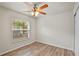 Bright bedroom features wood-look flooring and a ceiling fan with light fixture at 3795 Rachel St, Apopka, FL 32703
