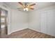 Bedroom featuring ceiling fan, closet, and wood floors throughout at 3795 Rachel St, Apopka, FL 32703