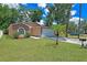 Single-story home featuring a well-manicured lawn, mature trees and an attached garage with decorative stone features at 3795 Rachel St, Apopka, FL 32703