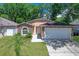 Charming single-story home with a two-car garage, stone accents, and a well-manicured lawn at 3795 Rachel St, Apopka, FL 32703