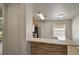 Eat-in kitchen with stainless steel appliances and a stone-accented breakfast bar overlooking the living room at 3795 Rachel St, Apopka, FL 32703