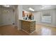 Open-concept kitchen featuring stone-accented breakfast bar, leading to the living area and front door at 3795 Rachel St, Apopka, FL 32703