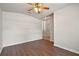 Living room featuring wood floors, ceiling fan, and open access to other parts of the home at 3795 Rachel St, Apopka, FL 32703