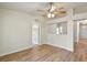 Bright living room featuring wood floors, ceiling fan, and white trim throughout at 3795 Rachel St, Apopka, FL 32703