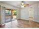 Living room featuring wood floors, sliding glass door, and view of the backyard at 3795 Rachel St, Apopka, FL 32703