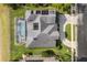 Aerial view showcasing the home's roof with solar panels and a screened-in pool in the backyard at 3891 Brantley Place Cir, Apopka, FL 32703
