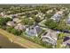 Aerial view of neighborhood featuring homes with screened pools, lush landscaping, and access to a tranquil lake at 3891 Brantley Place Cir, Apopka, FL 32703
