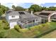 Backyard featuring a screened-in pool and patio, surrounded by lush greenery and providing a private outdoor space at 3891 Brantley Place Cir, Apopka, FL 32703