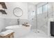 Bright bathroom featuring a modern soaking tub, walk-in shower, and elegant finishes at 3891 Brantley Place Cir, Apopka, FL 32703