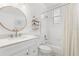 Updated bathroom with modern fixtures, a shower-tub combination, and a stylish round mirror at 3891 Brantley Place Cir, Apopka, FL 32703