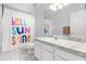 Bright bathroom featuring a sink with white cabinets and a shower with a colorful curtain at 3891 Brantley Place Cir, Apopka, FL 32703