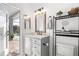 Bathroom featuring gray vanity with marble countertop, and an open door to the pool area at 3891 Brantley Place Cir, Apopka, FL 32703