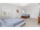 Spacious bedroom with two beds, white dresser, closet and two windows at 3891 Brantley Place Cir, Apopka, FL 32703