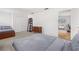Spacious bedroom with two beds, wooden dresser, closet and view of another room at 3891 Brantley Place Cir, Apopka, FL 32703