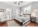 Comfortable bedroom with wood floors, a ceiling fan, neutral walls, and access to a private bathroom at 3891 Brantley Place Cir, Apopka, FL 32703