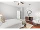 Bedroom showcasing hardwood floors, minimalist décor, and a cozy reading nook with a chair at 3891 Brantley Place Cir, Apopka, FL 32703