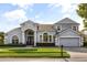 Beautifully landscaped single-Gathering home with a two-car garage and a well-manicured lawn at 3891 Brantley Place Cir, Apopka, FL 32703