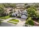 Charming two-story home with a well-manicured lawn and circular driveway, complemented by a serene pond view at 3891 Brantley Place Cir, Apopka, FL 32703