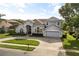 Charming two-story home with beautiful landscaping, driveway, and a two-car garage at 3891 Brantley Place Cir, Apopka, FL 32703