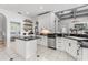 Open kitchen featuring white cabinetry, stainless appliances, and a central island, ideal for entertaining at 3891 Brantley Place Cir, Apopka, FL 32703