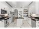 Stylish kitchen with white cabinetry, stainless steel appliances, and a functional island for cooking and dining at 3891 Brantley Place Cir, Apopka, FL 32703