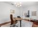 Home office featuring desk, chair, and view to a nearby living room at 3891 Brantley Place Cir, Apopka, FL 32703