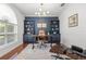 Modern office with built-in shelves, a comfortable chair, and natural light at 3891 Brantley Place Cir, Apopka, FL 32703