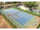 Tennis court with community playset, a fenced area, and landscaped perimeters, providing recreational amenities at 3891 Brantley Place Cir, Apopka, FL 32703