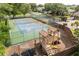 Community tennis court and adjacent playground with swing set and slide, surrounded by fencing at 3891 Brantley Place Cir, Apopka, FL 32703