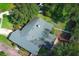 An aerial view of the home's roof, complemented by surrounding mature trees and well maintained landscaping at 4141 Fallwood Cir, Orlando, FL 32812