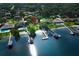 Stunning aerial shot of waterfront properties with private boat docks on a sunny day, surrounded by green trees at 4141 Fallwood Cir, Orlando, FL 32812